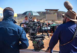 Two men beside a movie camera